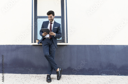 Full shot standing man with his tablet