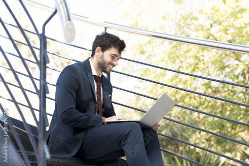 Side view smiley lawyer working on laptop