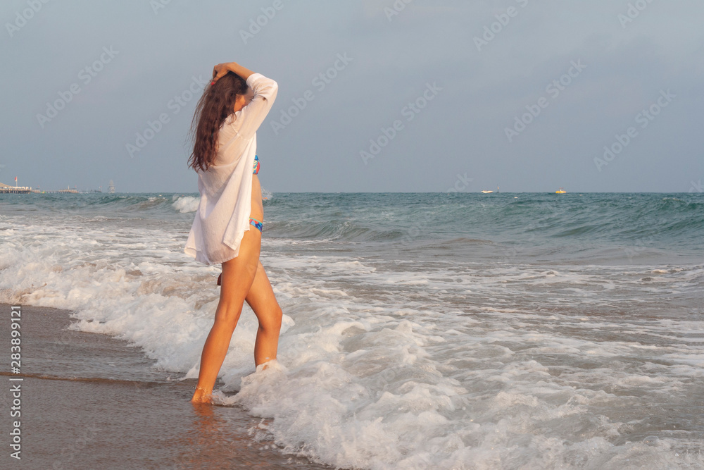 young woman walking on the beach young woman walking on the beach