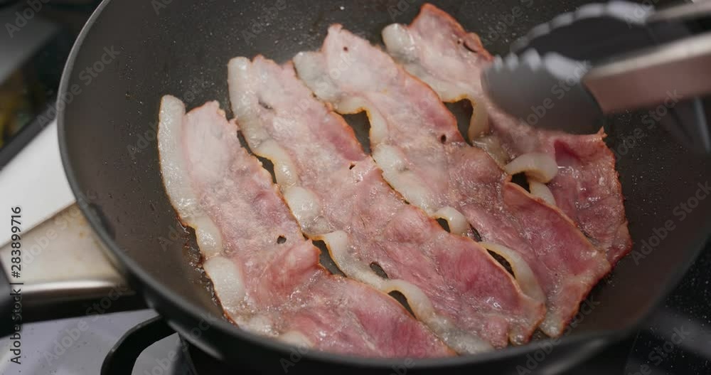 Fry bacon in pan in kitchen for breakfast Fry bacon in pan in kitchen for breakfast