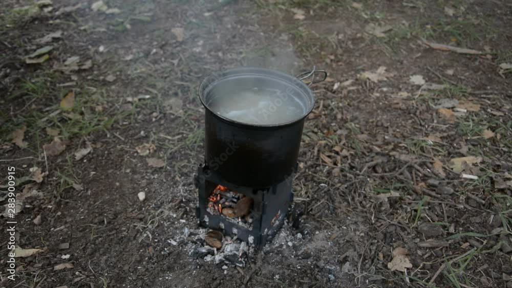 cooking potatoes on a gas stove on a hiking trip cooking potatoes on a gas stove on a hiking trip