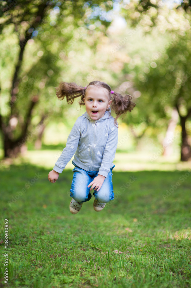 Portrait of a little girl jumping high up Portrait of a little girl jumping high up