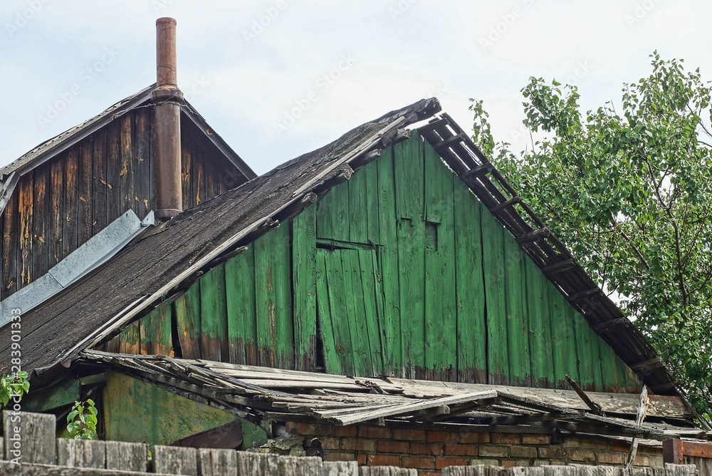 old green wooden loft with the door of a rural house old green wooden loft with the door of a rural house
