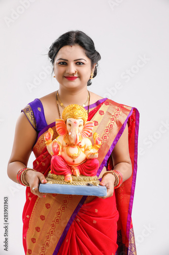 Happy young Indian woman Celebrating Ganesh Festival , woman with ganesha photo