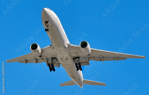 Big modern Boeing jet commercial plane in blue sky including clipping path