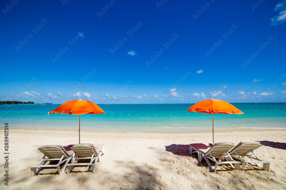 Parasols and sand beach in Mauritius island Parasols and sand beach in Mauritius island