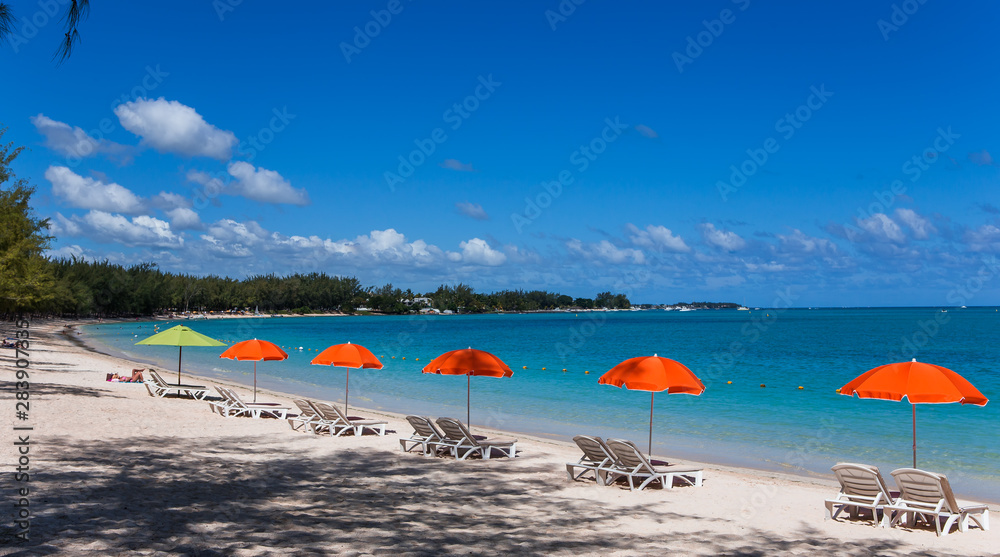 Parasols and sand beach in Mauritius island Parasols and sand beach in Mauritius island