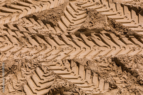 Truck work machine wheel tracks in the sand, in a real estate development area