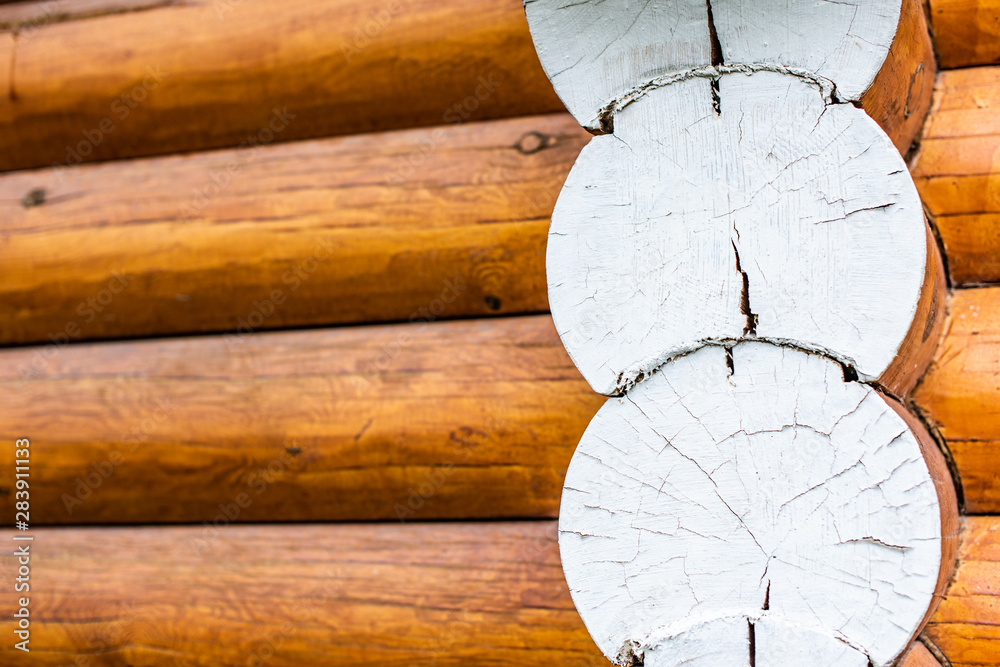 Closeup view of corner of wooden house made of natural logs - wooden construction background Closeup view of corner of wooden house made of natural logs - wooden construction background