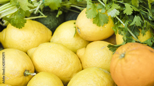 Close-up of juicy lemon with fresh coriander in market stall