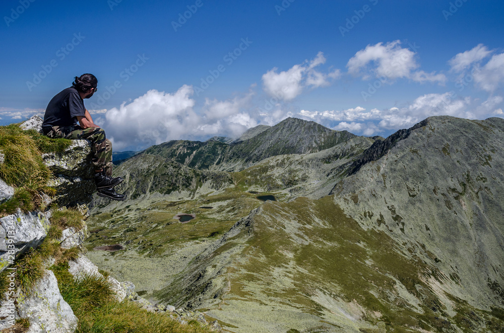 Man admiring the rocky mountain landscape in Retezat National Park, Carpathian Mountains, Romania