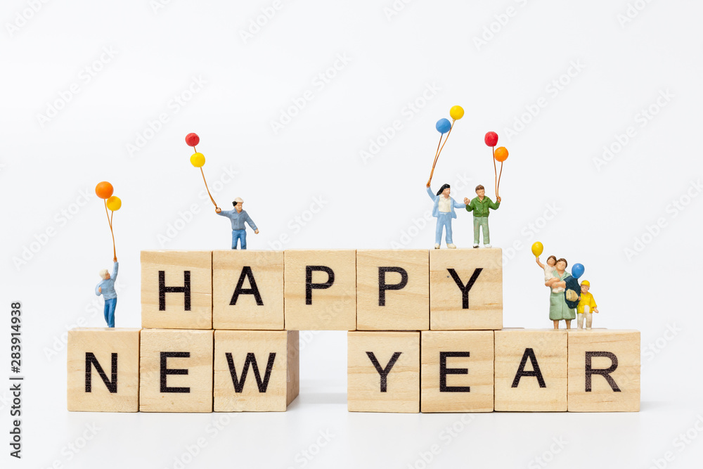 Miniature people Miniature people : Happy family standing on wooden block  Happy new year concept