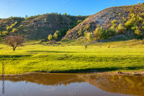 natural green hills and lake in the spring 