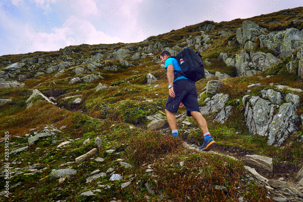 Obraz premium Hiker with backpack in the mountains