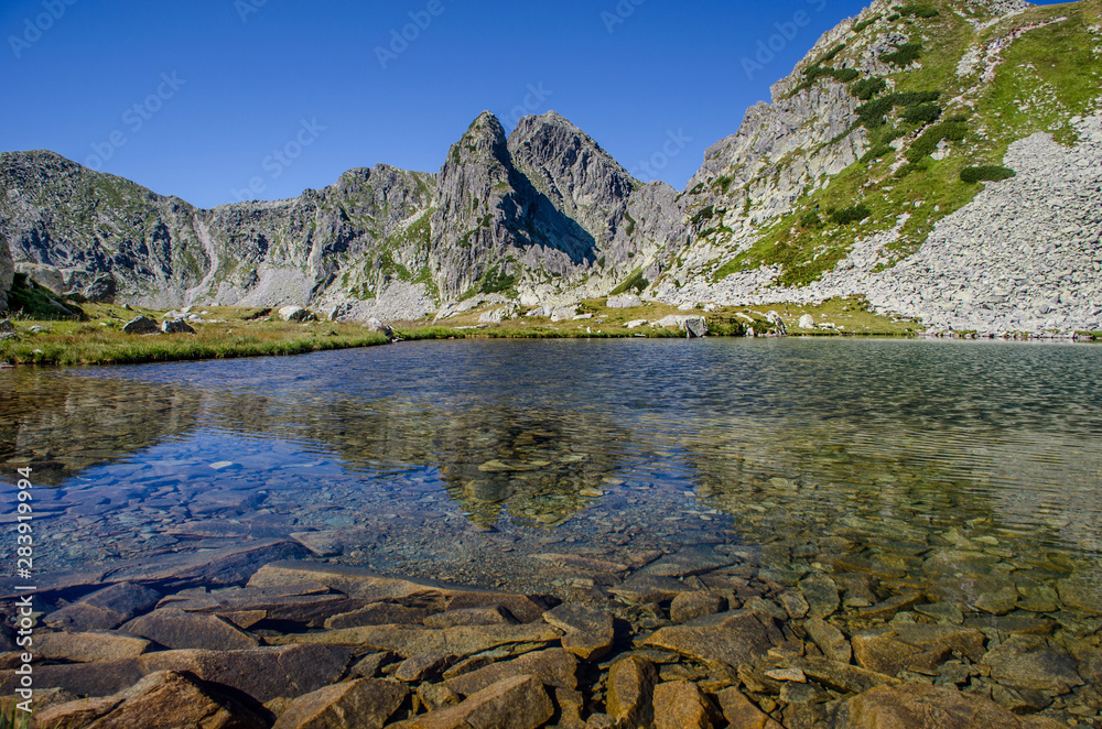 Mountain landscape and glacial Taul Portii lake in Retezat National Park, Carpathian Mountains, Romania
