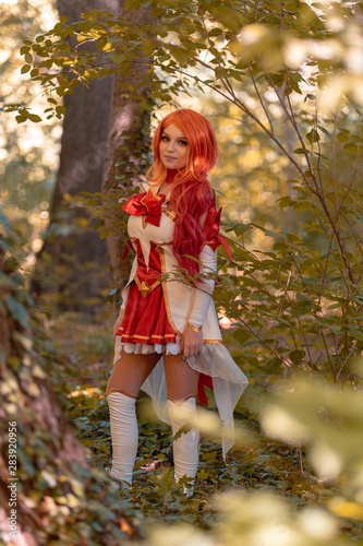 young red head girl play cosplay miss fortune from leaque of legends in the woods. photo