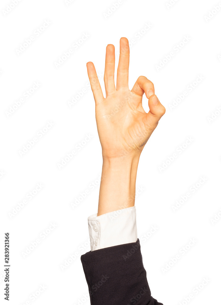 Female hand in business suit giving Okay gesture Female hand in business suit giving Okay gesture