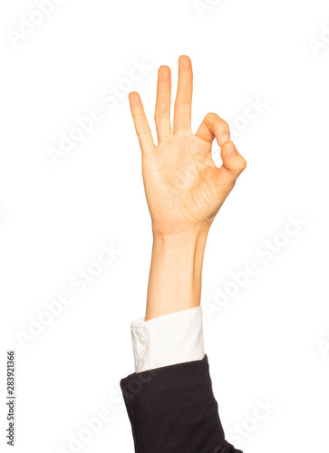 Female hand in business suit giving Okay gesture