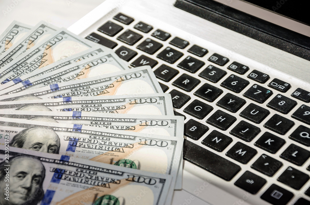 dollars on a laptop keyboard. Close-up dollars on a laptop keyboard. Close-up