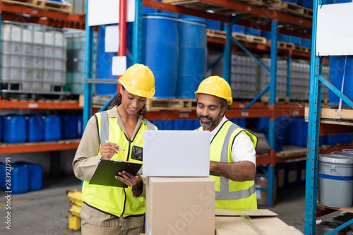 Male and female worker working together in warehouse