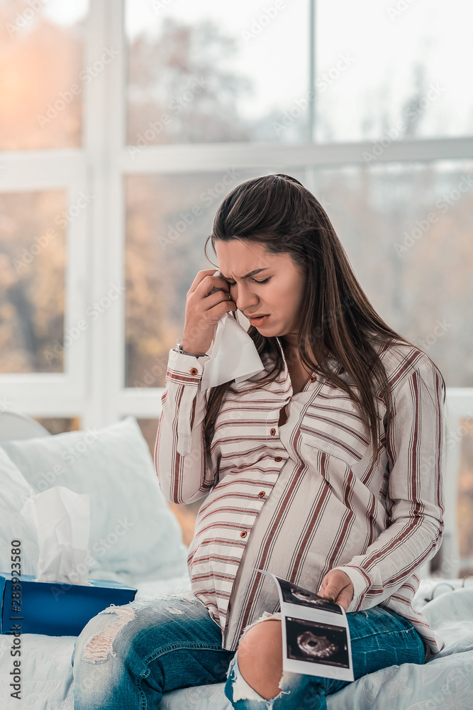 Negative delighted pregnant woman touching her forehead Negative delighted pregnant woman touching her forehead