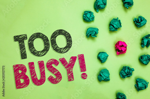 Text sign showing Too Busy. Conceptual photo No time to relax no idle time for have so much work or things to do Crumpled wrinkled papers one different pink unique special green background photo