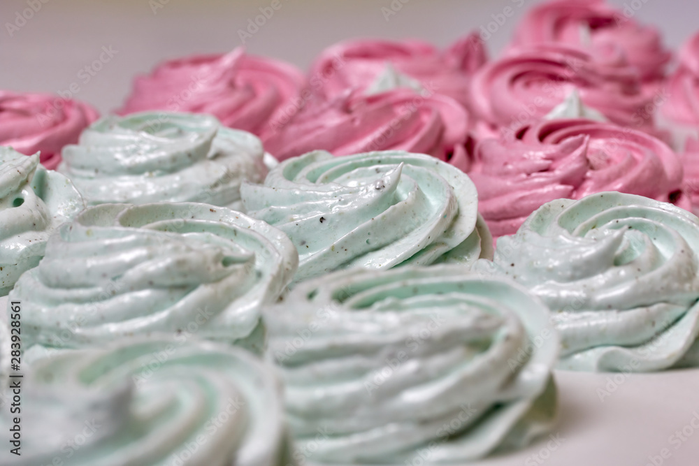 Freshly made marshmallows lie on the surface of the table. It is stabilizing Freshly made marshmallows lie on the surface of the table. It is stabilizing