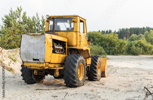 Bulldozer in the sand pit. Construction machinery after work.
