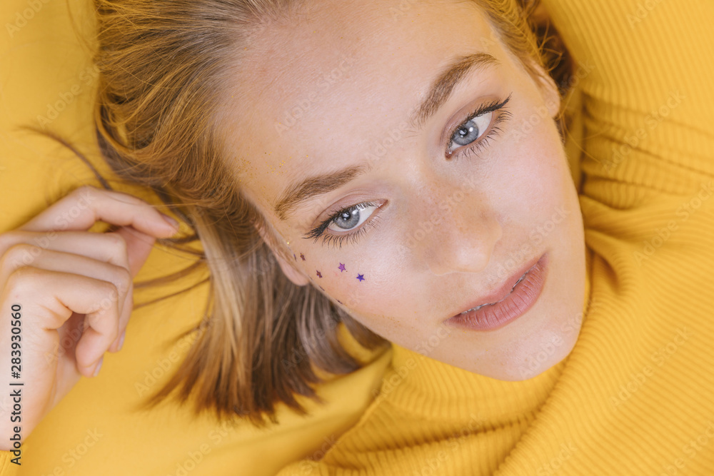 Portrait of woman lying in a yellow scene Portrait of woman lying in a yellow scene