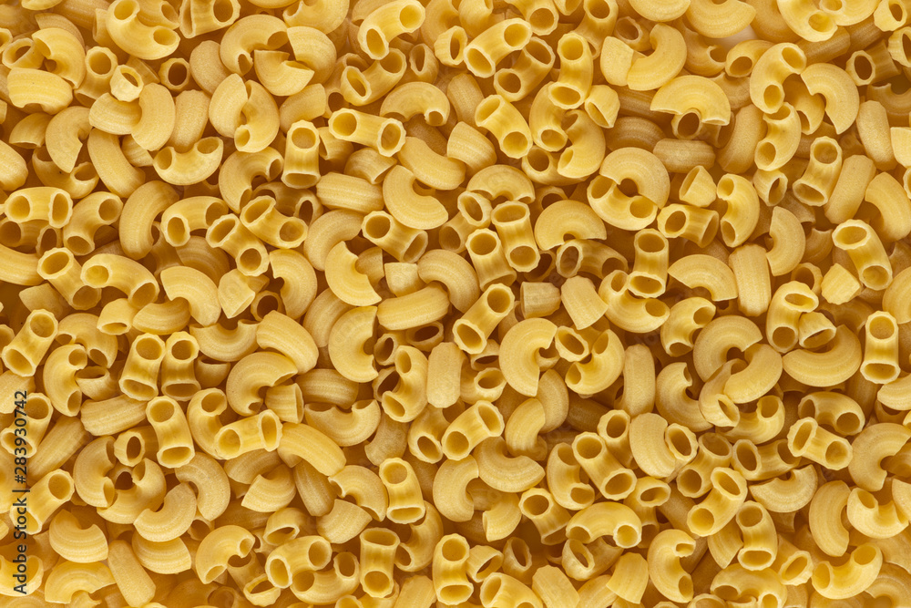 A lot of elbow macaroni shape of italian pasta as background on banner A lot of elbow macaroni shape of italian pasta as background on banner