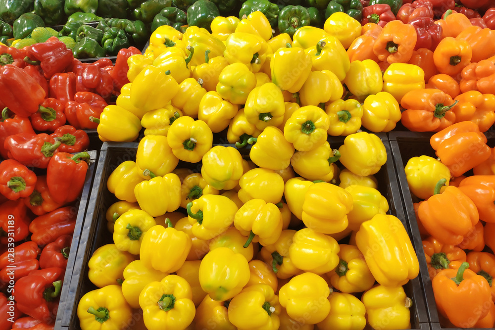 Bell pepper of different colors on the shop window. Organic products.