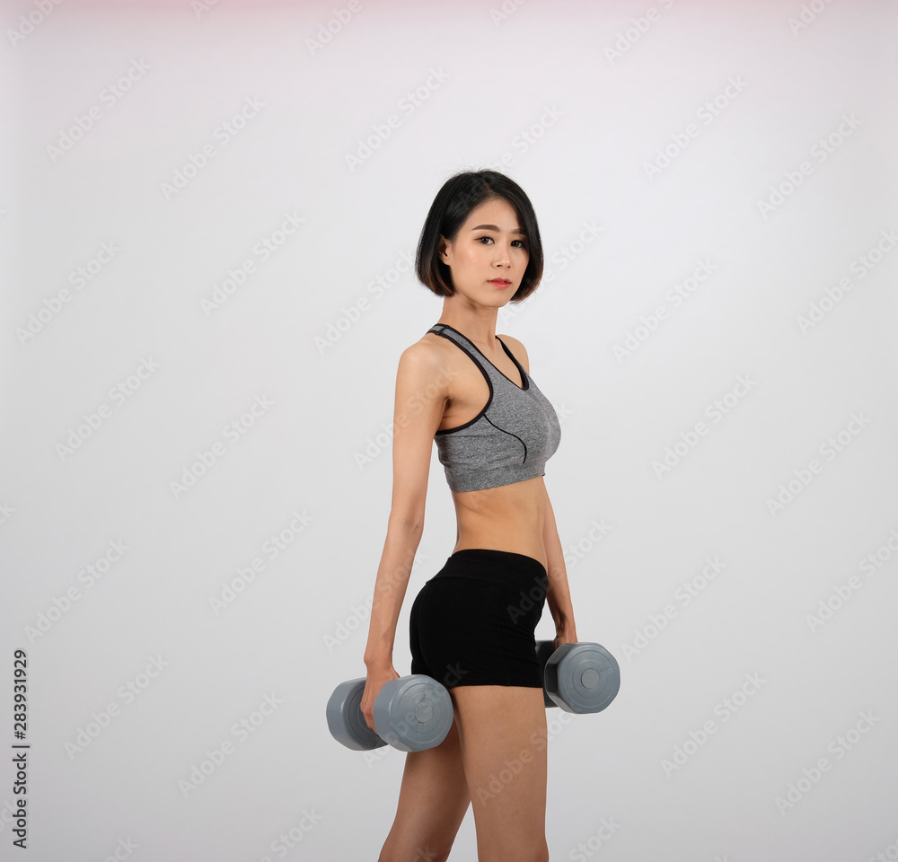 sporty woman in sportswear with dumbbell doing fitness workout on white background. healthy sport lifestyle