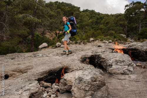 Smoldering fires in front of female tourist