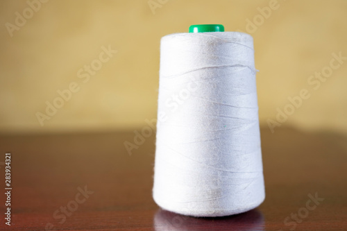 Spool of thread on the table