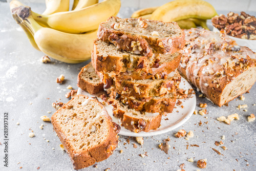 Homemade banana bread with walnuts, gray stone concrete background copy space, Vegan food. photo