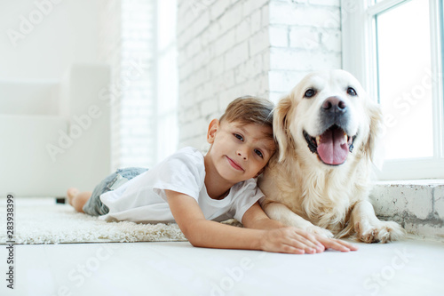 Fototapeta Naklejka Na Ścianę i Meble -  Children with a dog. Little boy at home with a dog. 