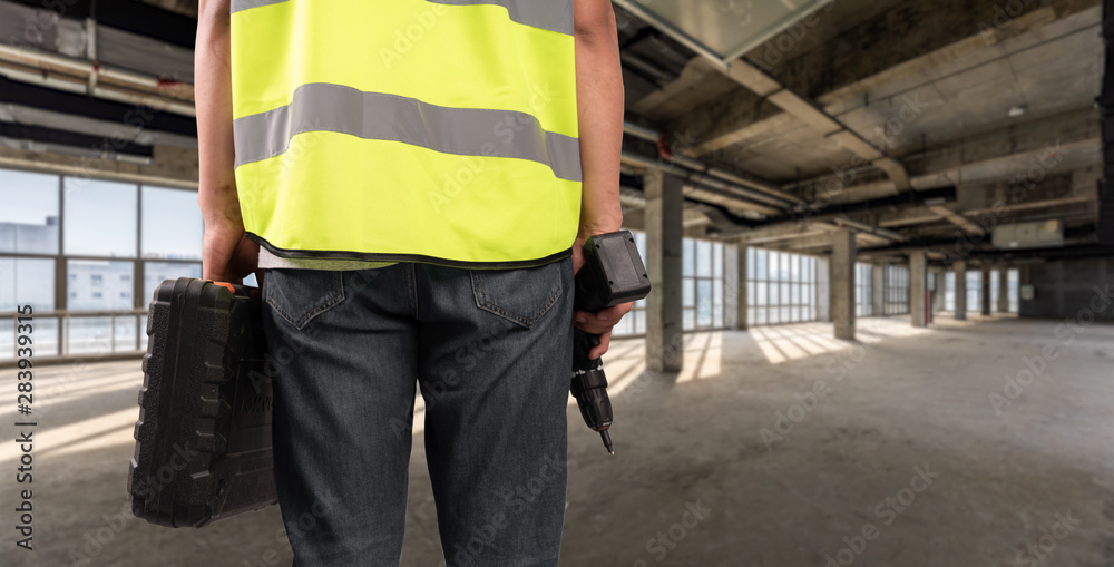 Construction Worker in front of construction site Construction Worker in front of construction site