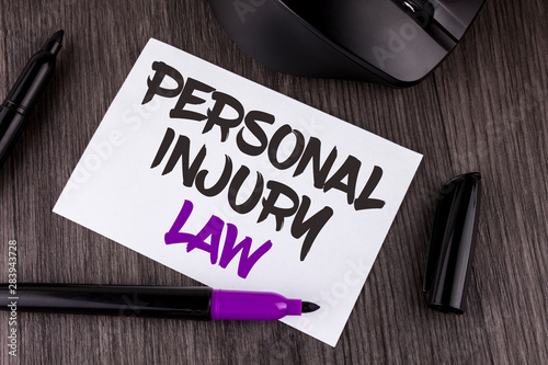 Handwriting text writing Personal Injury Law. Concept meaning guarantee your rights in case of hazards or risks written White Sticky Note Paper the wooden background Mouse Markers photo