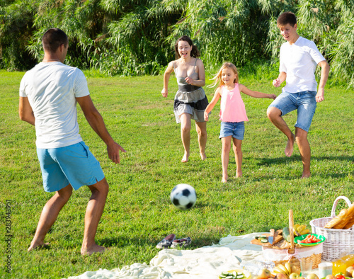 Happy family playing football