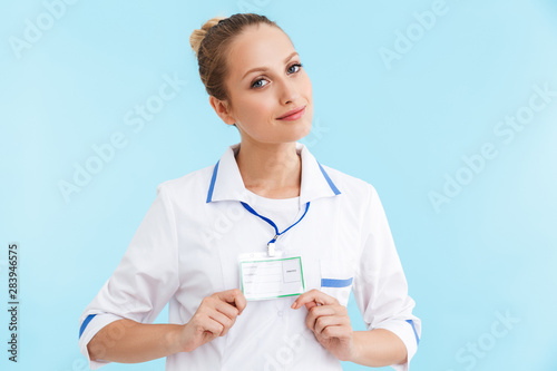 Beautiful blonde woman doctor wearing uniform standing