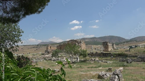 Hierapolis, Pamukkale, Denizli, Turkey - 16th of July 2019: 4K View on the temple of Apollo and theatre from Cleopatra facilities photo