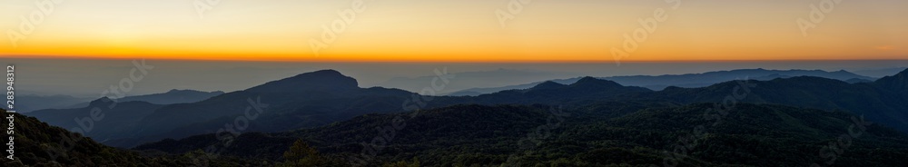 Fototapeta premium Panoramic of the rainy season with foggy at morning, Mountain top view of sunrise landscape in the rainforest, Thailand.