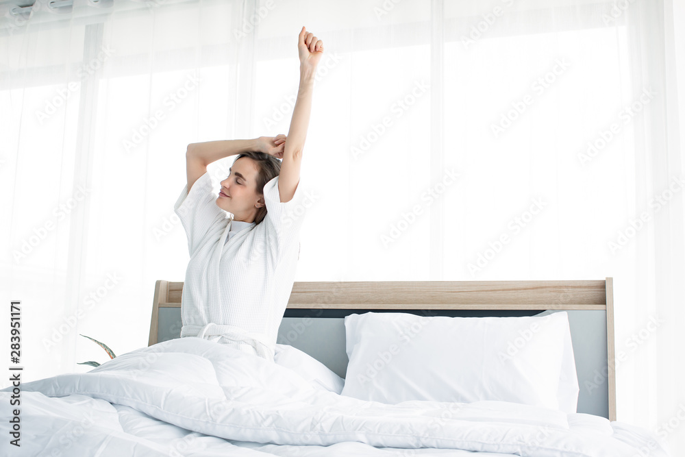 Woman stretching after waking up in the morning.
