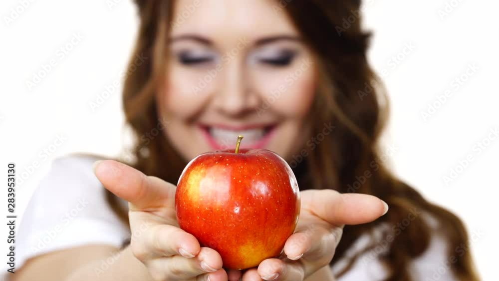 Young brunette woman recommend healthy eating diet, holding red apple in hands, focus on fruit, isolated on white Young brunette woman recommend healthy eating diet, holding red apple in hands, focus on fruit, isolated on white