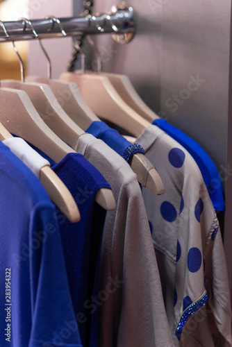 hangers with clothes in blue and silver colors
