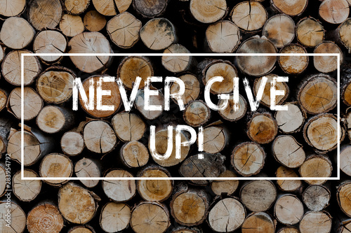 Conceptual hand writing showing Never Give Up. Concept meaning Be persistent motivate yourself succeed never look back Wooden background vintage wood wild message ideas thoughts