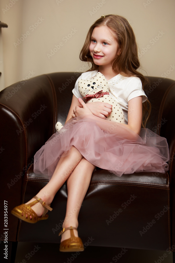 Little girl is sitting on the couch Little girl is sitting on the couch