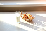 Healthy breakfast with croissant and milk.