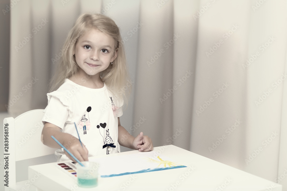 Little girl draws paints.montessori education. Little girl draws paints.montessori education.