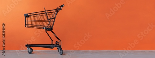 Shopping cart on an orange background photo